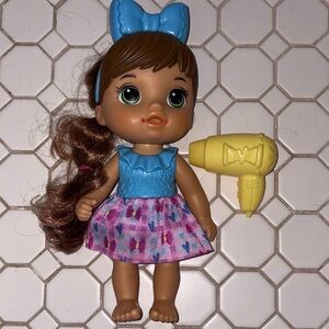 Adorable Doll with Blue Bow and Yellow Hair Dryer